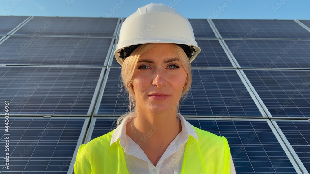 Female ecological engineer with a roll of paper where there are drawings Green energy. Environment Female ecological engineer with a roll of paper where there are drawings Green energy. Environment