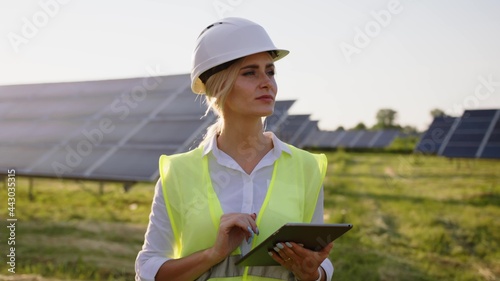 Inspector Engineer Woman Holding Digital Tablet Working in Solar Panels Power Farm, Photovoltaic Cell Park, Green Energy Concept