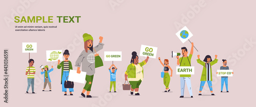 environmental activists holding posters go green save planet strike concept mix race protesters campaigning to protect earth demonstrating against global warming full length copy space horizontal