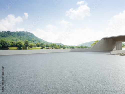 Abstract architecture design of modern building. Empty parking area floor and concrete wall with mountain and blue sky lake view. 3D rendering background image for car scene. photo