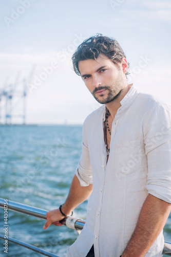 Young man outdoor portrait, hand made jewelry on his neck