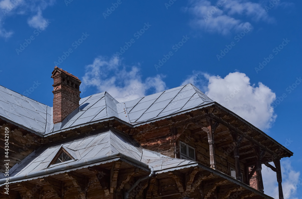 Top of old wooden house. Wooden old facade of the house. Facade of the old log house in the of wooden architecture. 