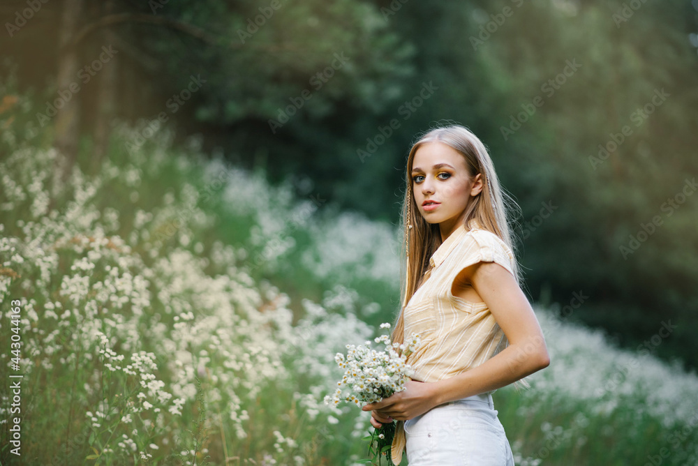 Portrait of a sweet gentle girl in a field of white flowers Portrait of a sweet gentle girl in a field of white flowers