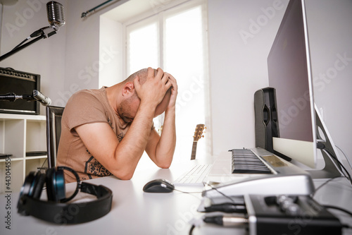 Картината върху платно desperate adult man working in home studio when recording software is crashing