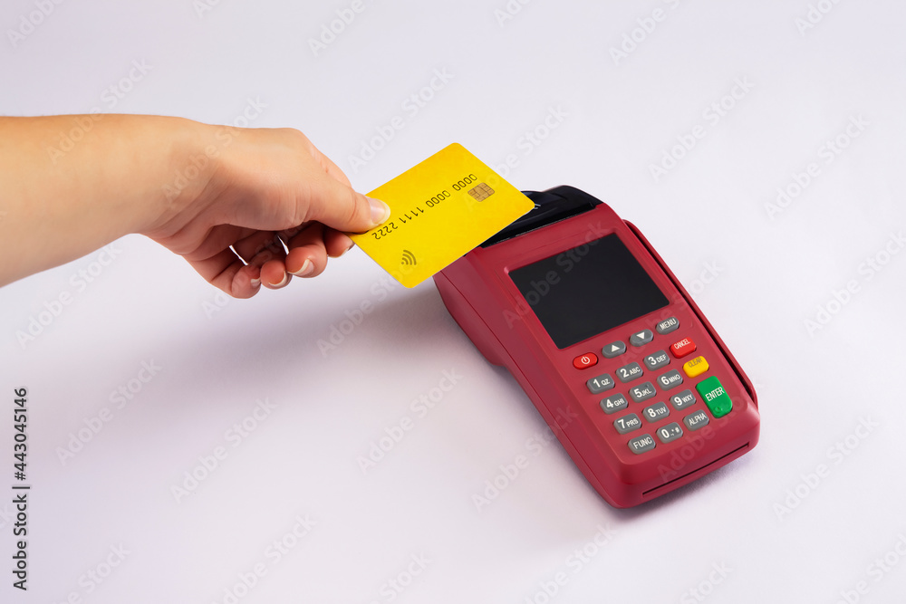 A human hand swiping card in swipe machine. A human hand swiping card in swipe machine.