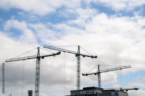 Construction Cranes over City skyline 