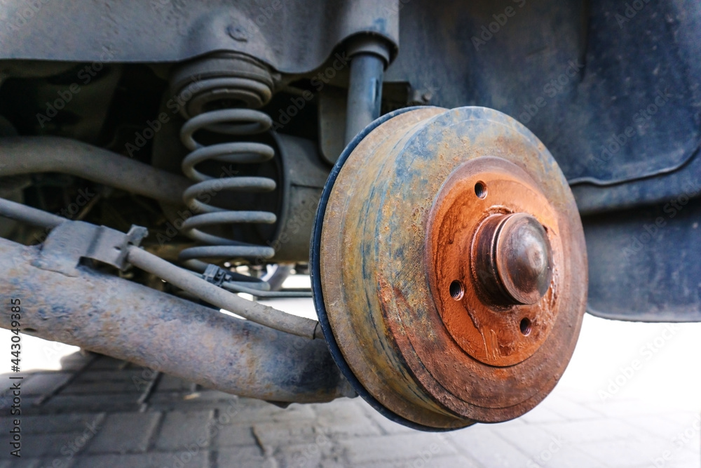 Brake drum and spring of the shock absorber of the rear wheel of the car. Close-up Brake drum and spring of the shock absorber of the rear wheel of the car. Close-up