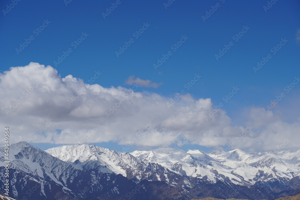 Nature scene - Aerial view Peak of Snow Mountain of himalayan mountains with clouds blue sky at Leh Ladakh , Jammu and Kashmir , India                                