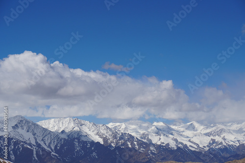 Nature scene - Aerial view Peak of Snow Mountain of himalayan mountains with clouds blue sky at Leh Ladakh   Jammu and Kashmir   India                                