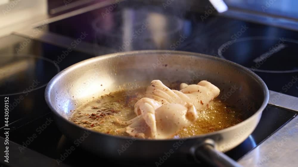 Squid grilling on hot pan. Chef cooking delicious seafood squid in restaurant summer menu. Fresh grill food preparation on family party Squid grilling on hot pan. Chef cooking delicious seafood squid in restaurant summer menu. Fresh grill food preparation on family party