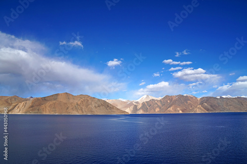 Landscape Lake Nature Scene of Pangong tso or Pangong Lake with Snow mountain background is best famous destination at Leh Ladakh ,Jammu and Kashmir , India - Blue nature travel Background - travel