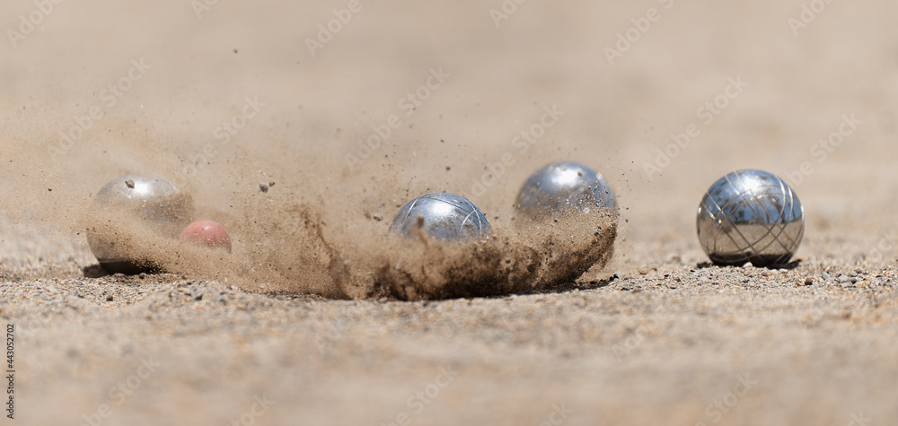 Petanque ball boules bowls on a dust floor, photo in impact. Balls and a  small wood jack Photos | Adobe Stock