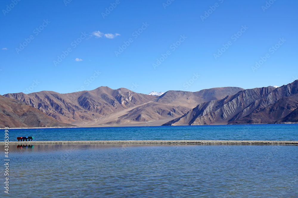 Landscape Lake Nature Scene of Pangong tso or Pangong Lake with Snow mountain background is best famous destination at Leh Ladakh ,Jammu and Kashmir , India - Blue nature travel  Background - travel