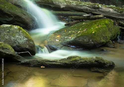 Waterfall near Boone in North Carolina coursing through boulders and over a log photo