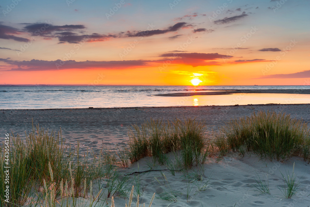 Fototapeta premium A beautiful sunset on the beach of the Sobieszewo Island at the Baltic Sea. Poland