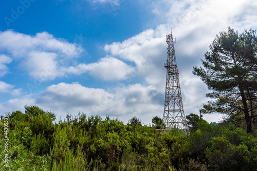 Old radio station in a wooded and natural setting, with a bubbly blue sky in the background.