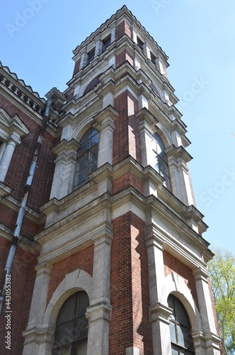 High wing of an old building. Manor house of a noble estate made of red bricks with white trim. The main house of the Bykovo estate. 