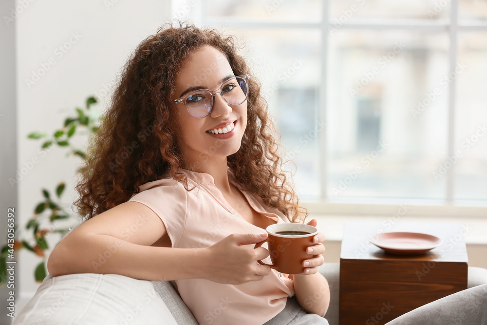 Beautiful young woman drinking coffee at home Beautiful young woman drinking coffee at home