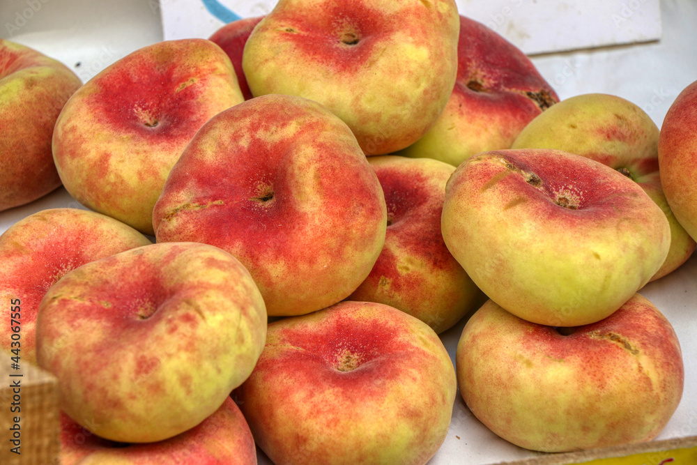 Close up of flat peach also known as the donut peach or Saturn peach Close up of flat peach also known as the donut peach or Saturn peach