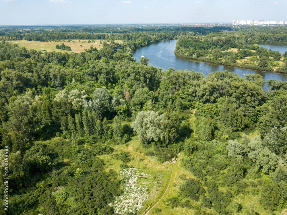 Green meadow near the river in summer. Aerial drone view. Green meadow near the river in summer. Aerial drone view.