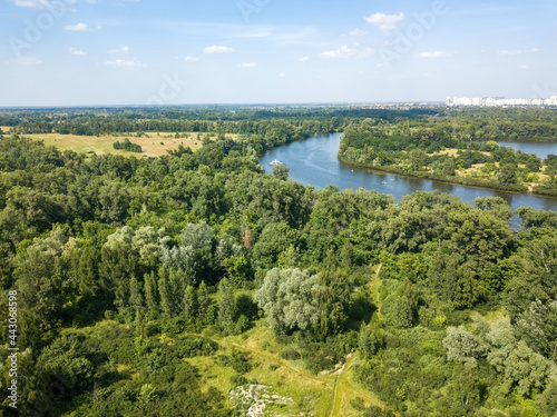 Green meadow near the river in summer. Aerial drone view. © Sergey