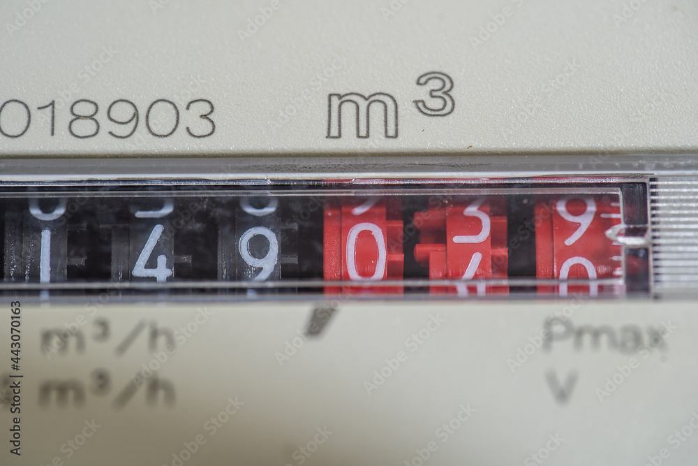 A closeup view of the dial or face of a metric gas meter in home A closeup view of the dial or face of a metric gas meter in home