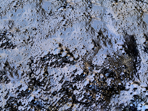 Boiling hot bubbling pitch asphalt surface texture  photo
