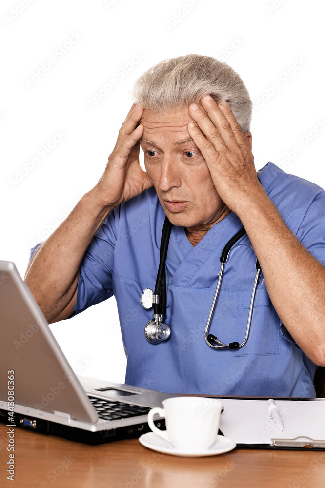 confused doctor with a laptop on white background confused doctor with a laptop on white background