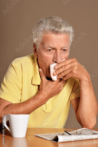 Close up portrait of sad sick senior man with sore throat
