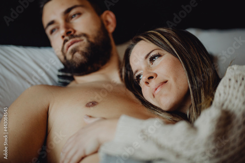 Happy couple hugging on bed photo