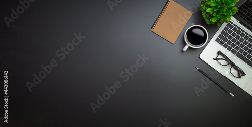 Workspace - Flat top view illustration of a workspace with a coffee cup and notebook on the black desk surface,Office desk concept. photo