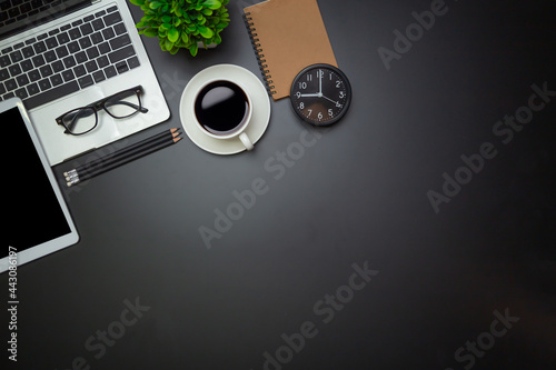 Workspace - Flat top view illustration of a workspace with a coffee cup and notebook on the black desk surface,Office desk concept.