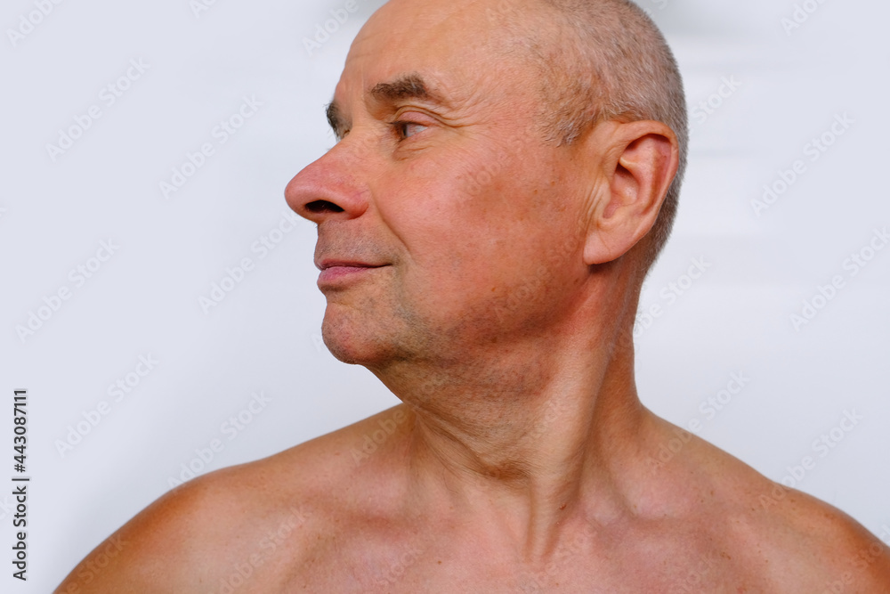 close-up face of elderly bald tanned man 60 years old with a naked torso looking to the side, profile, wrinkles and age spots, aging problems, concept of male age, midlife crisis close-up face of elderly bald tanned man 60 years old with a naked torso looking to the side, profile, wrinkles and age spots, aging problems, concept of male age, midlife crisis