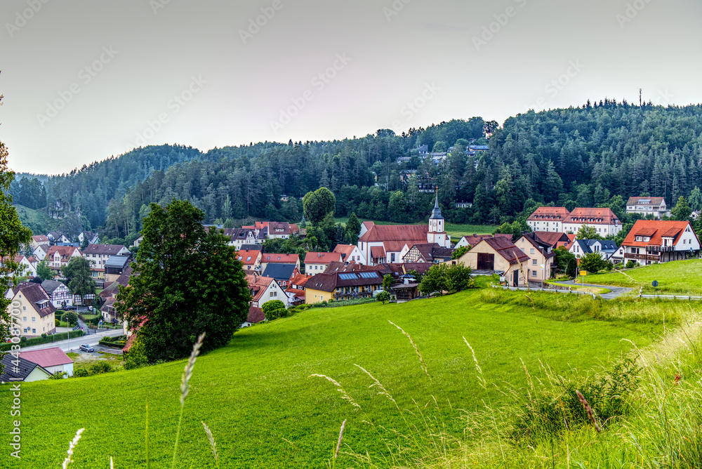 scenic view of a village with a church in the mountains scenic view of a village with a church in the mountains