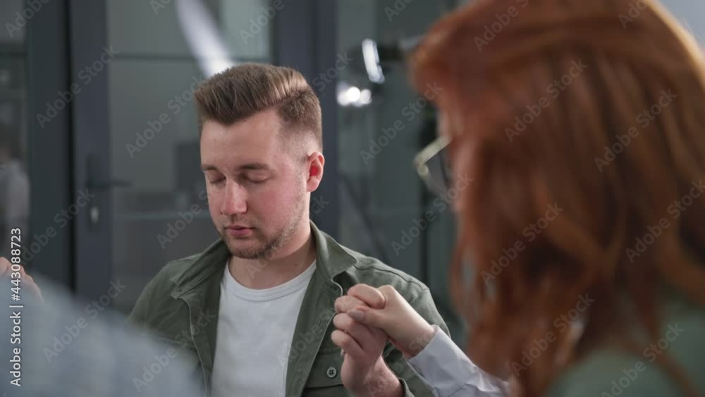 portrait of a young man holding the hands of friends and with closed eyes prays to God during a group therapy session portrait of a young man holding the hands of friends and with closed eyes prays to God during a group therapy session