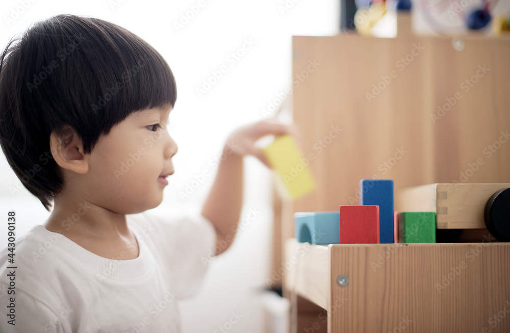 Little asian boy playing blocks in the room : close up