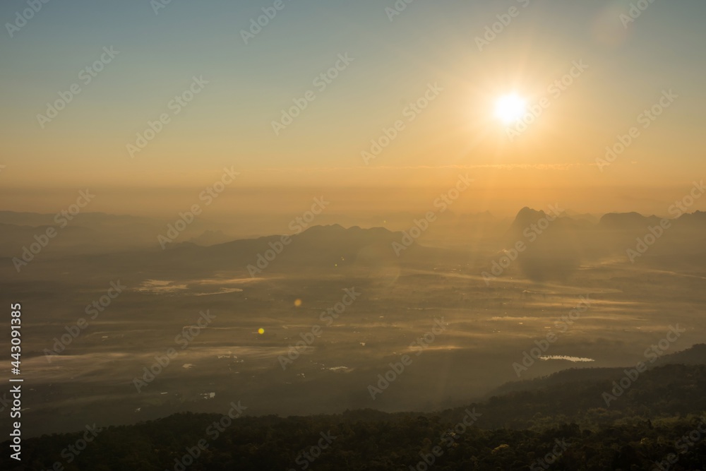 Fototapeta premium The landscape of nature, mountain and village view of during sunrise taken in Phukradueng, Loey, Thailand . Taken in warm filter and soft focus effect. 