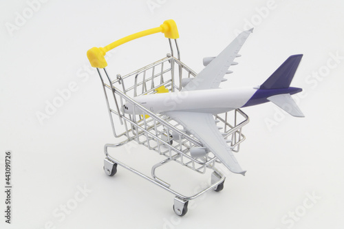 Airplane model in shopping cart. Buy air tickets and travel tour concept.  © Valerii Evlakhov