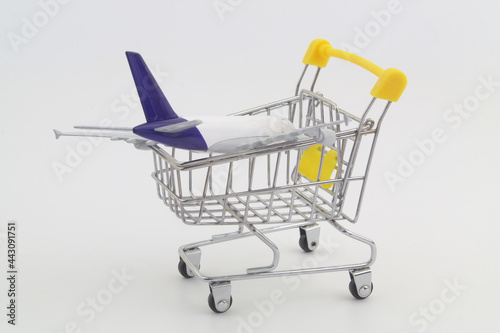 Airplane model in shopping cart. Buy air tickets concept. © Valerii Evlakhov