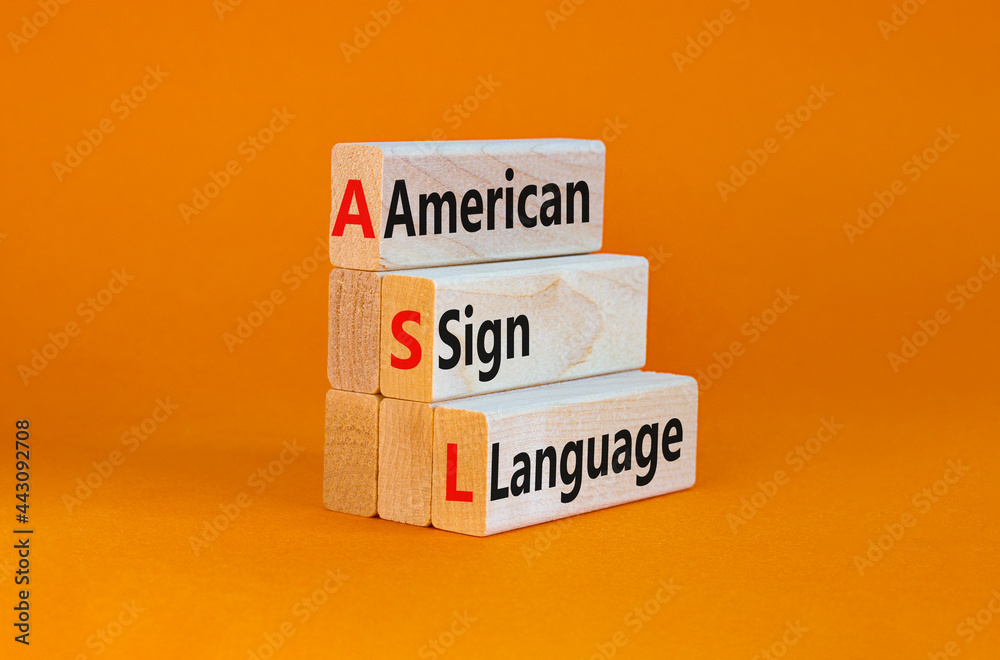 Naklejka premium ASL, american sign language symbol. Wooden blocks with words 'ASL, american sign language'. Beautiful orange background. Medical and ASL, american sign language concept. Copy space.