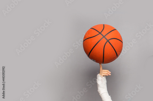 Boy with basket ball and broken hand © PEPPERSMINT