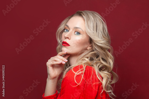 Fashion portrait of stylish woman with perfect makeup. Beautiful model woman with curly hairstyle. Care and beauty  lady in red dress