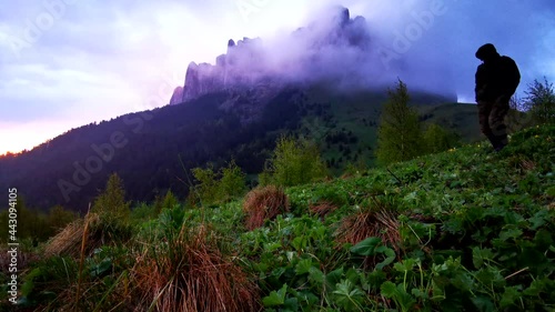 Flower fields, fast flying clouds in mountain landscape. Timelapse video