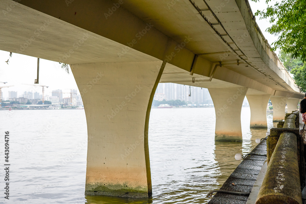 Close-up of the piers of the urban viaduct crossing the river