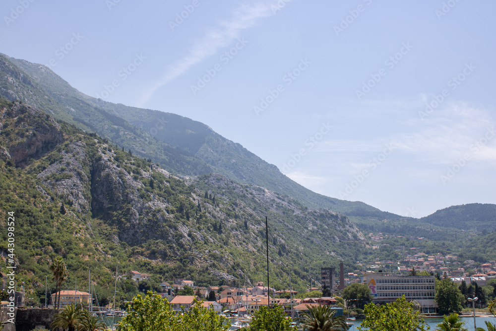 Old town of Kotor Montenegro on the mountains and blue sky background. The bright beautiful landscape in the summer on a clear day.