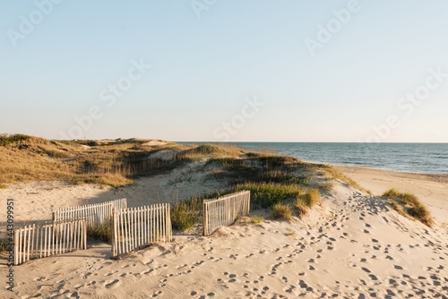 Slika na platnu A sandy beach with a white fence, Outer Banks, North Carolina