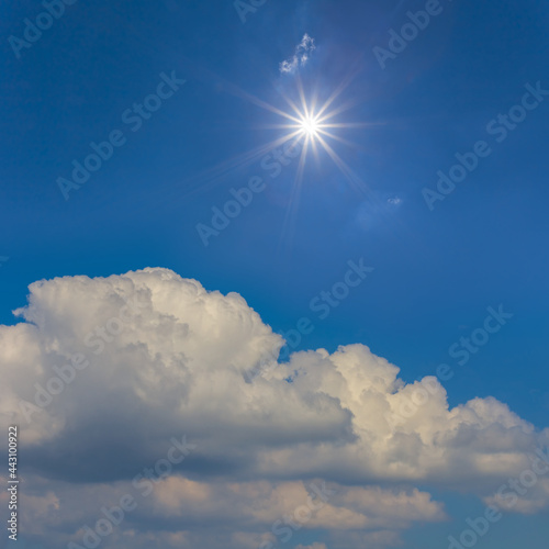 sparkle sun above dense cumulus clouds  natural sky background