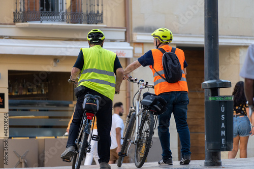 Retired men with bikes and emergency gilet 