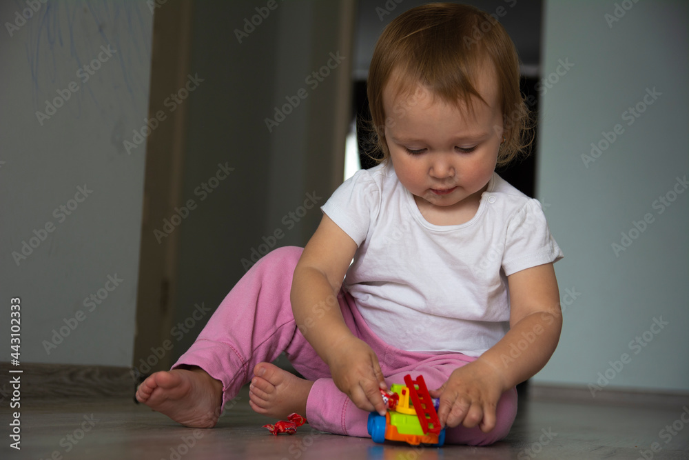 Little beautiful one-year-old girl is played with toys Little beautiful one-year-old girl is played with toys