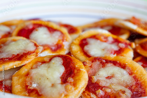 Homemade Pizzette ( Mini Pizza ) a Classic Italian Recipe for Aperitivo  with Mozzarella and tomatoes sauce .Italian style .Traditions food. Italy. photo